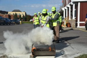 4H Program Leaders practice extinguishing a fire
